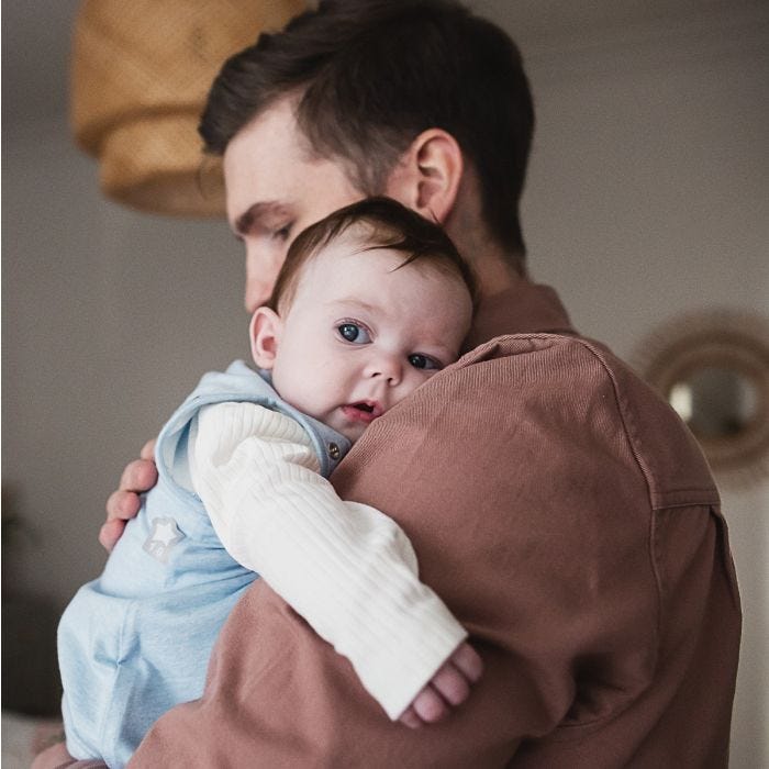 Parent holding baby in The Original Grobag Blue Marl Snuggle