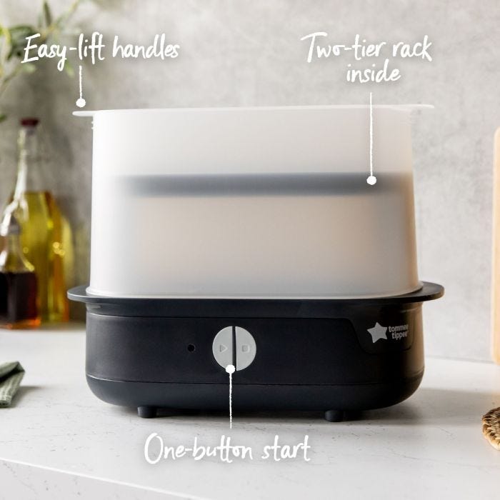 Black steam steriliser on kitchen counter with pointers to its easy-lift handles, one-button start and two-tier rack