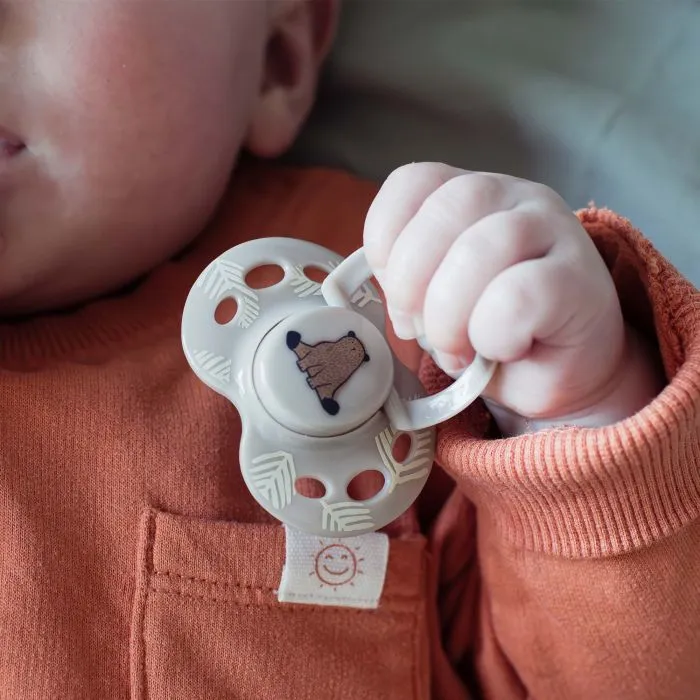 Close up of pacifier in baby’s hand