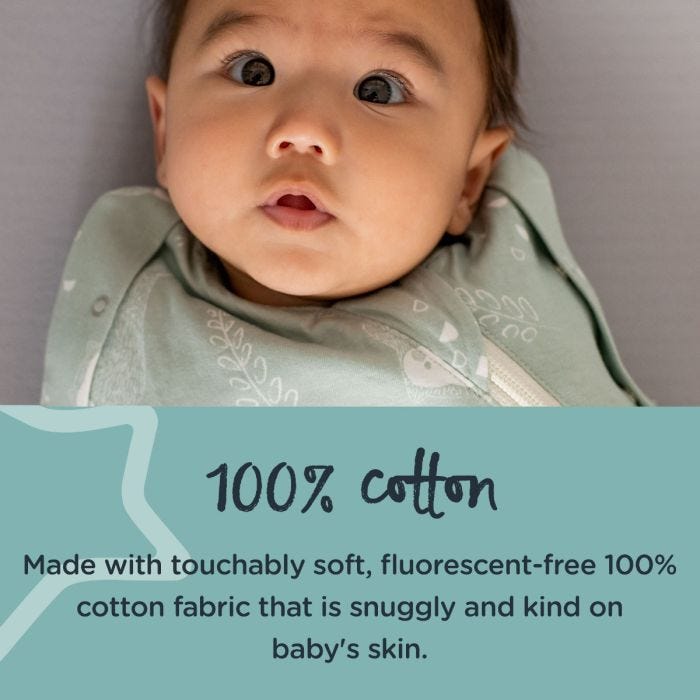 Baby lying down in woodland swaddlebag looking at the camera with text about how it is made from 100% cotton