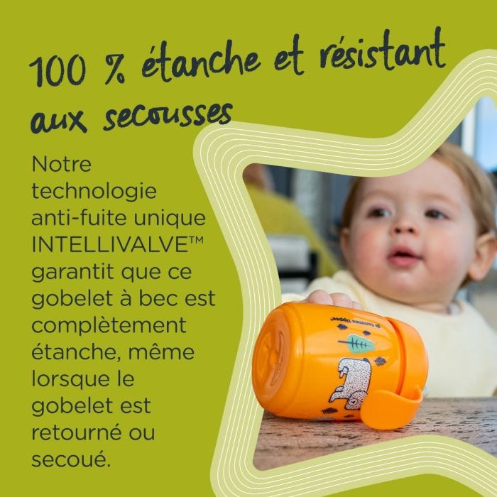 Tasse d&apos;apprentissage orange posée à plat sur une table, avec texte sur la valve anti-fuite