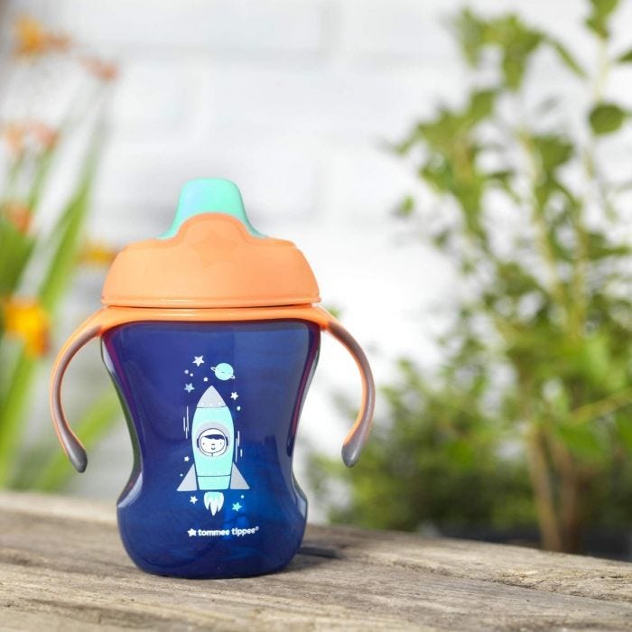 royal-blue-space-kid-sippee-cup-with-space-kid-design-on-garden-bench
