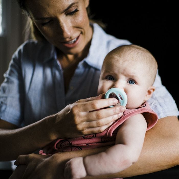 mum placing breast like soother in baby mouth
