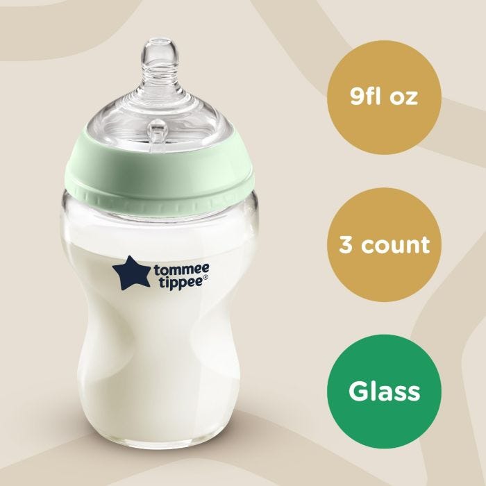 Glass baby bottle on beige background with roundels stating 9fl oz, 3 count, glass.