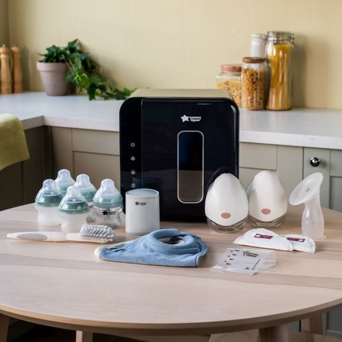 Photo of the products in the express to feed bundle, including a wearable pump, UV steriliser, bottle warmer and baby bottles in a home setting.