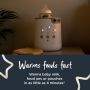 Baby bottle inside bottle warmer with text about how it warms feeds fast