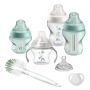 Newborn bottle feeding set with 4 Closer to Nature bottles, a teat, a soother and a bottle brush on a white background.