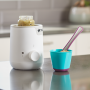 Baby food jar placed inside Easi-Warm warmer and food pot with spoon on kitchen counter