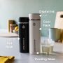 Hot and cool flask on a kitchen counter with pointers to the cooling base and digital lid