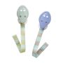 2 soother holders, 1 green and 1 blue, on a white background next to product packaging.