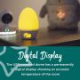 Groegg illuminated yellow in a dark room with texting saying it has a digital display