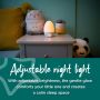 Groegg2 illuminated yellow on bedside table with text stating that it is adjustable