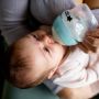 Baby drinking from a 150ml Closer to Nature Anti-Colic baby bottle.