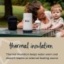 Woman sitting at a picnic bench with her baby and travel bottle warmer with text about thermal insulation