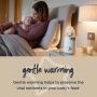 Mom sitting in bed with baby next to Easi-Warm warmer on bedside table above text about gentle warming
