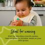 Baby sitting in highchair wearing a bib with text about how the blender is ideal for weaning