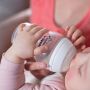 Baby with bottle in hands