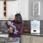 Mother with baby and steriliser in the background 