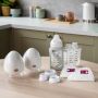 Product imagery of contents of wearable breast pump bundle in a home setting