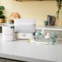 Product imagery of contents of bottle feeding starter bundle in a home setting