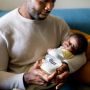 Father holding baby and Closer to Nature bottle