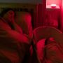 Mum and baby sleeping with red-glowing Dreammaker on the shelf