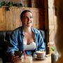 Woman using the double wearable breast pump at a café
