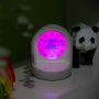 Connected sleeping trainer clock on a windowsill with a pink face