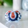 Green Fun Style soother with a fox design, on a white table.
