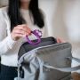Mum placing Kalani sensory mini teether in handbag