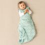 Baby wearing Tommee Tippee treasure trees sleepbag with hands touching