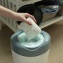 Someone placing a dirty diaper into their Simplee bin