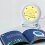 ollie the owl groclock next to open book