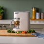 White quick cook on kitchen counter with vegetables inside the basket and on the chopping board