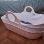pink moses basket on floor
