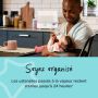 Père nourrissant son bébé dans une cuisine avec stérilisateur à vapeur blanc en arrière-plan et texte sur l&apos;organisation