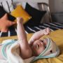 baby lying on bed swaddle in dry towel