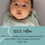 Baby lying down in woodland swaddlebag looking at the camera with text about how it is made from 100% cotton