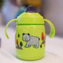 green superstar training sippee cup placed outdoors