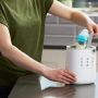 mum placing bottle in the 3-in-1 Advanced Electric Bottle and Pouch Warmer