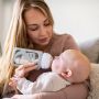 mum feeding baby using breast milk pouch