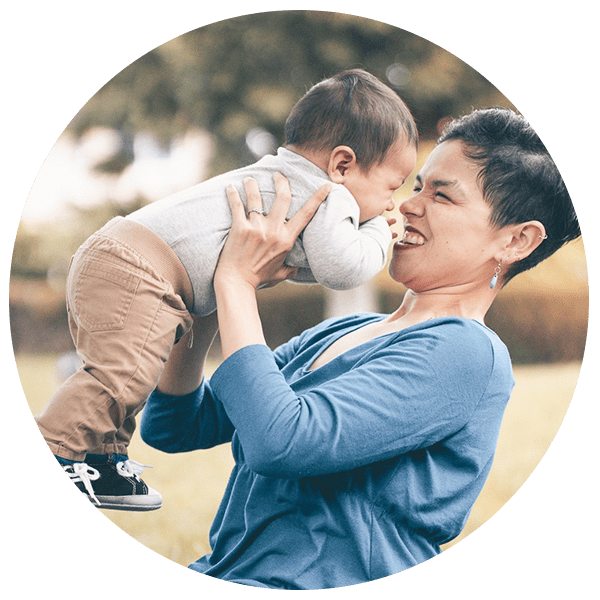 a mum holding her baby and laughing