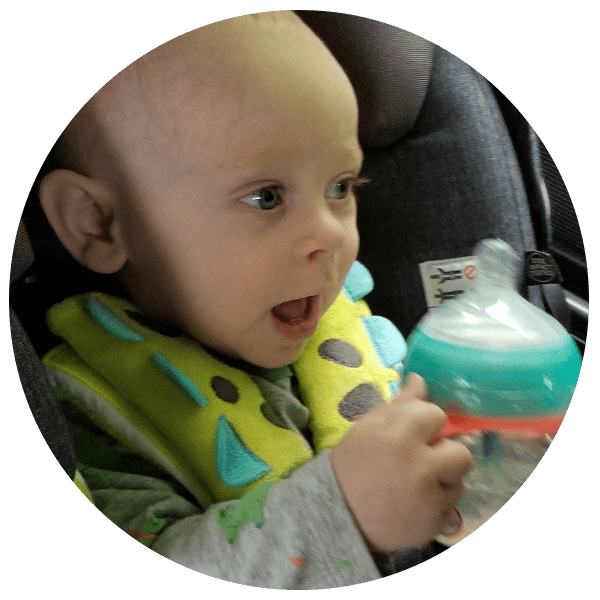 a baby drinking from a tommee tippee bottle