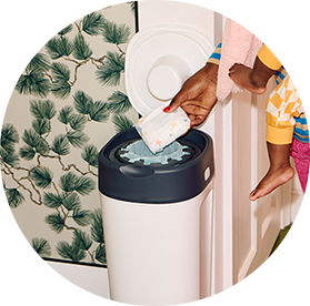 A mum using a tommee tippee nappy disposal bin