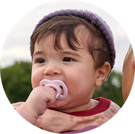 a baby with a tommee tippee ultra-light soother in his mouth