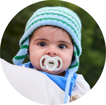 a baby sleeping with a tommee tippee in his mouth