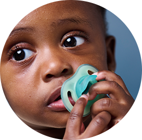 a baby with a tommee tippee ultra-light soother in his mouth
