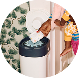 A mum using a tommee tippee nappy disposal bin