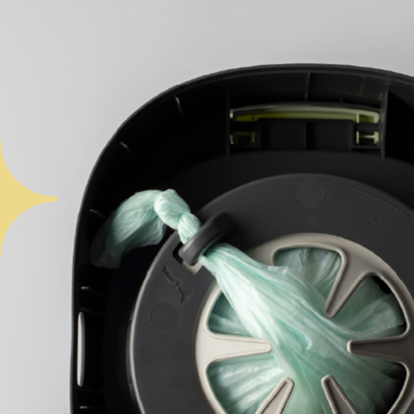 A close-up image of the Twist & Click film secured to the hook inside the bin.