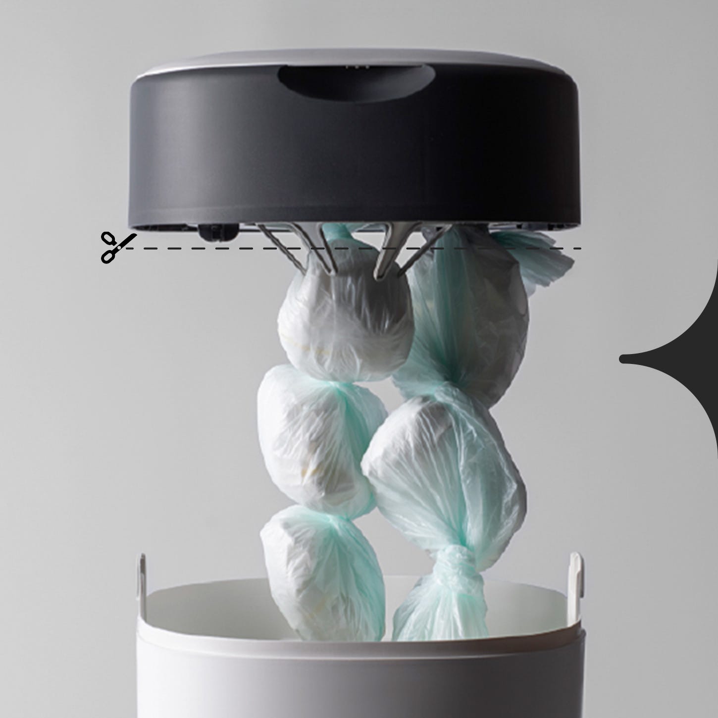 Image showing a full Twist & Click bin, with annotations showing where to cut the film, once you’re ready to remove the nappies from the bin.